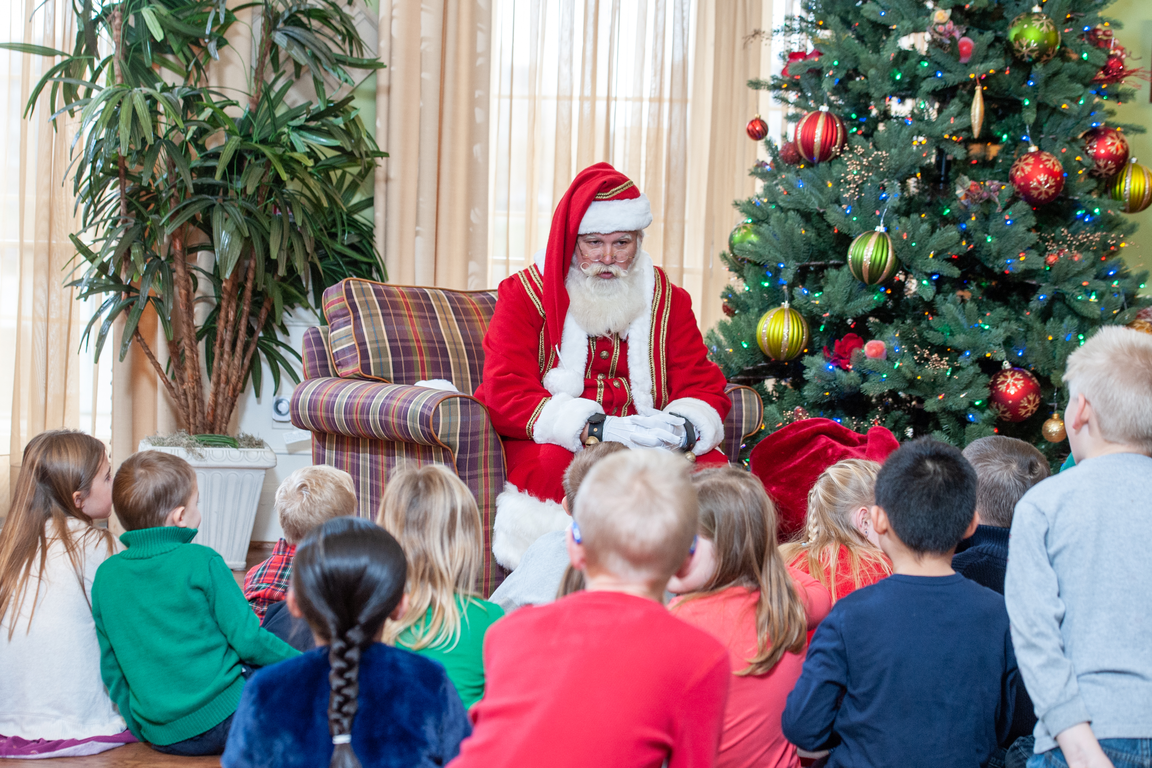 Our resident children listen intently to one of Santa's stories at the Cookies with Santa event.  Just one of many events held each year and coordinated by our Activities Committee. thumbnail