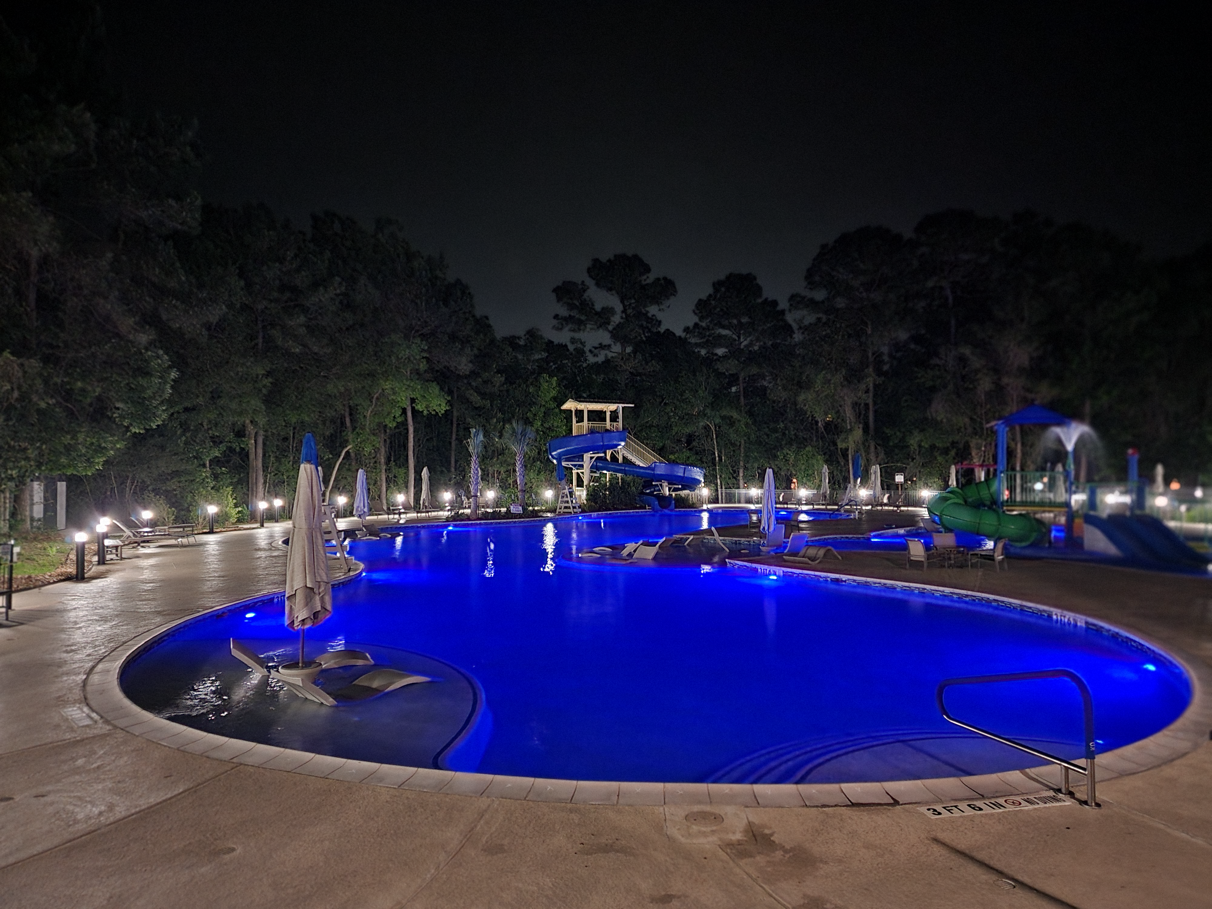 Resort-style pool at night with color changing LED pool lights thumbnail