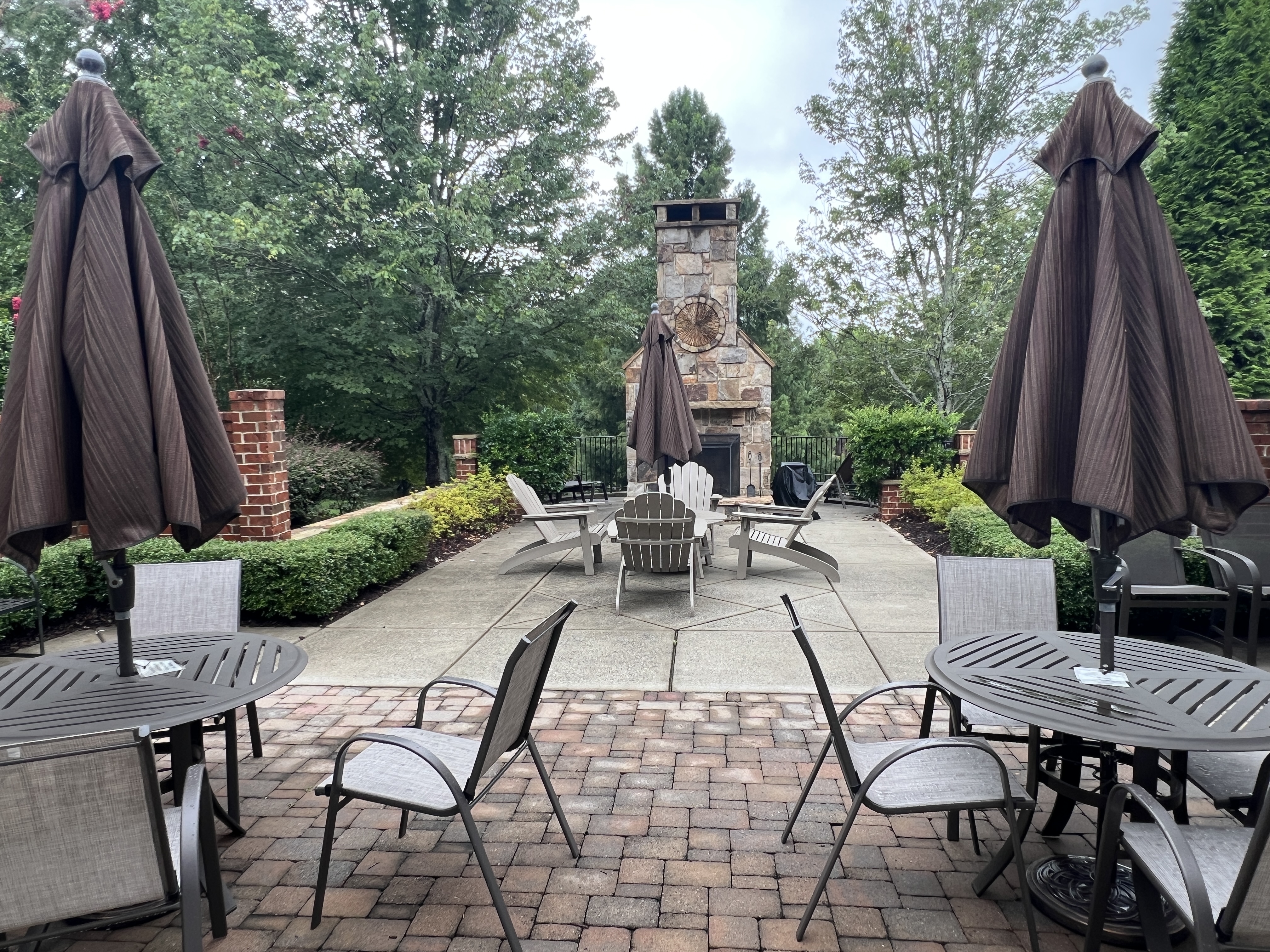 outdoor seating with a fireplace and grill. thumbnail